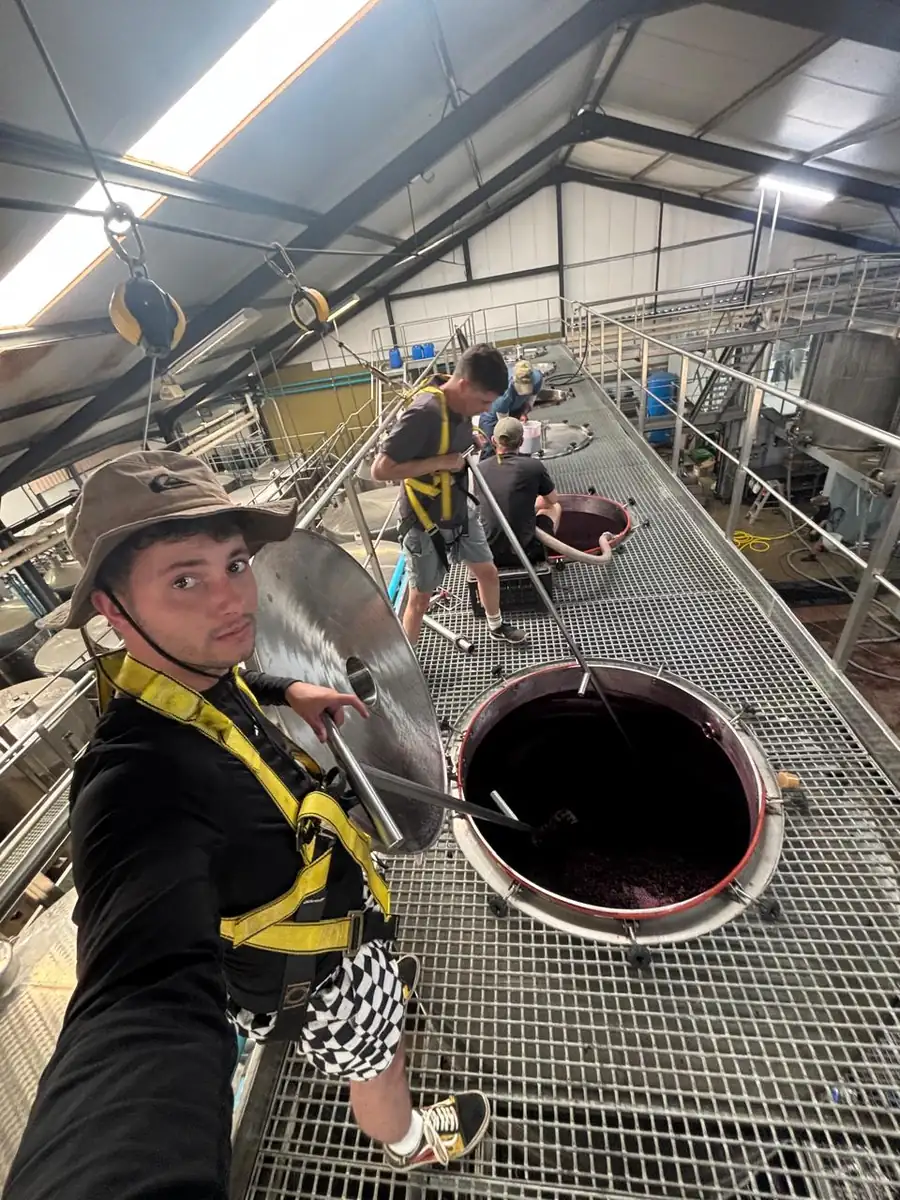 Working on the catwalk above open tanks wearing a fall harness