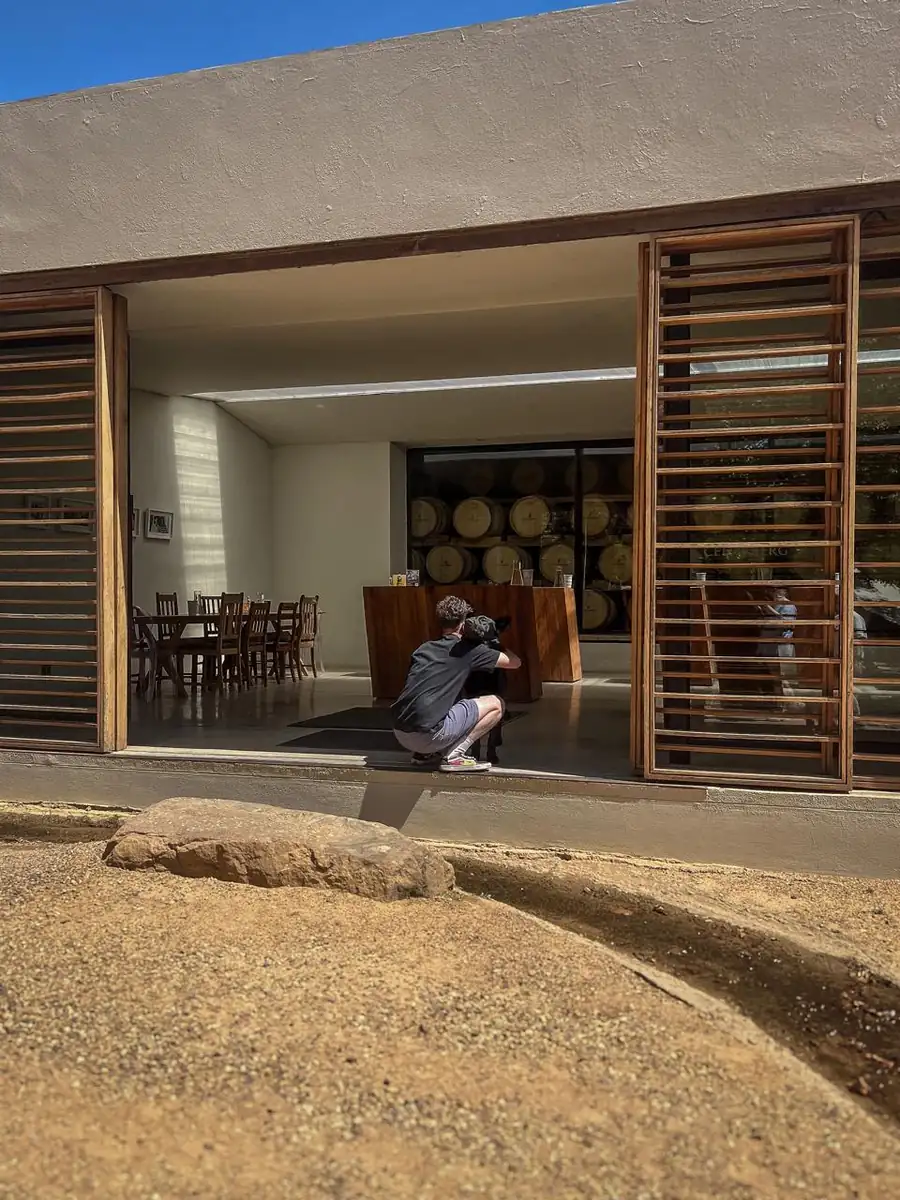 The tasting room from outside, and the cellar dog.