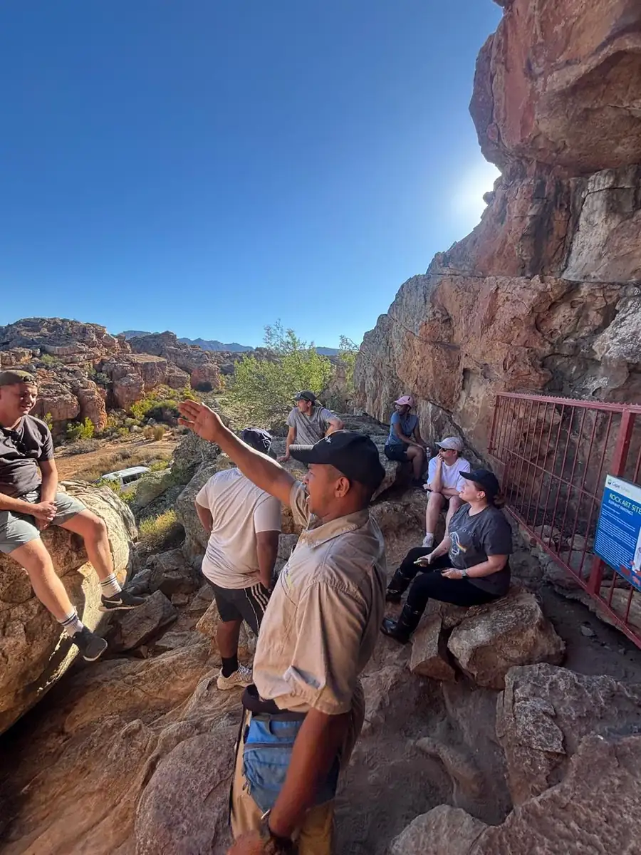 A guide talking to the group at the rock art site